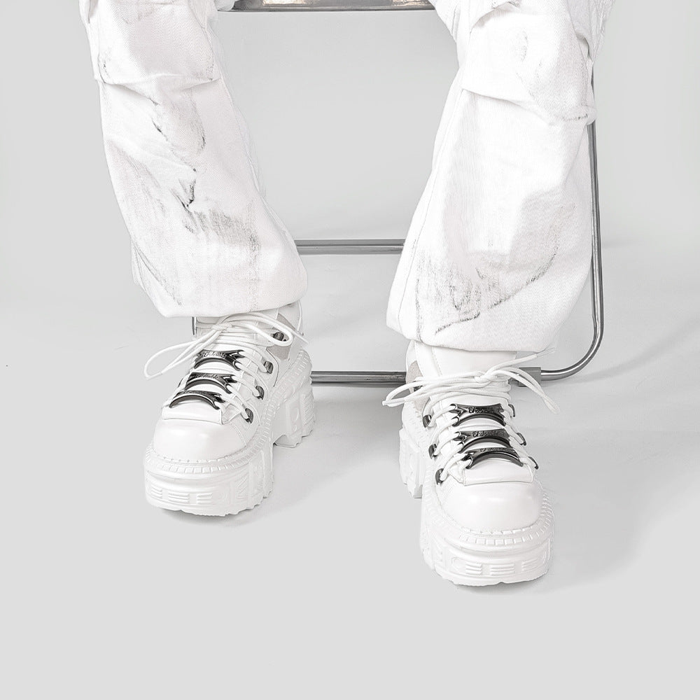 Extra-thick bottom punk boots by Erabyte in white, featuring chunky soles and metallic laces, worn with white marbled pants.