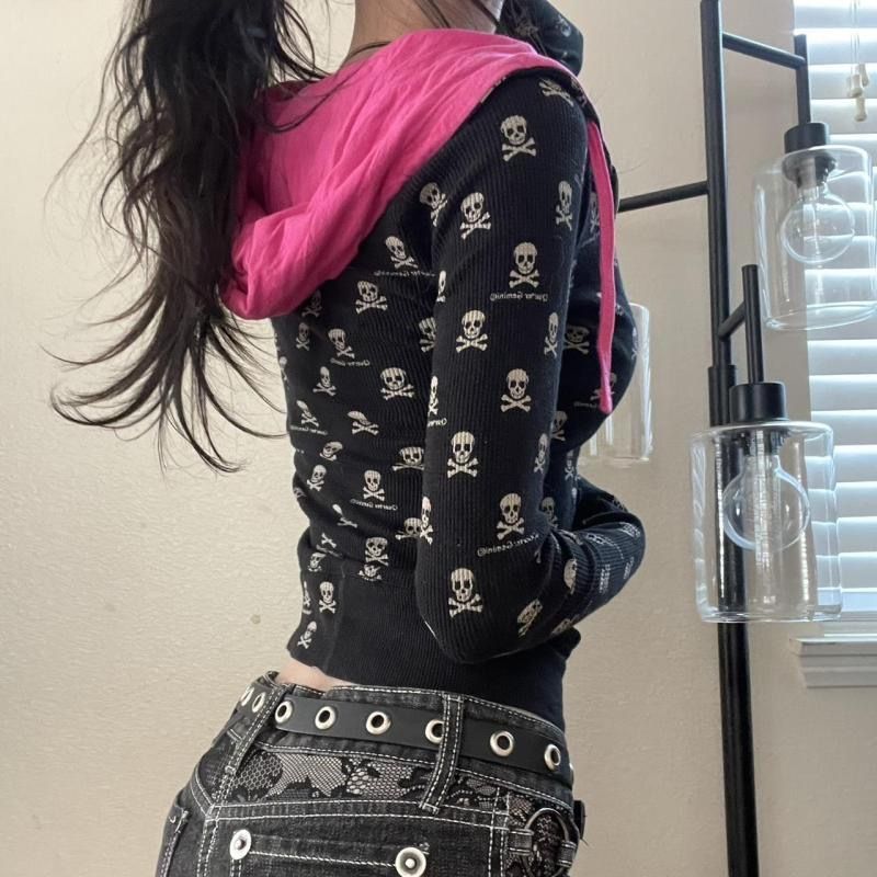 Erabyte Punk Skull Print Zipper Hoodie features a black design with skull patterns and a pink hood, styled with edgy jeans.