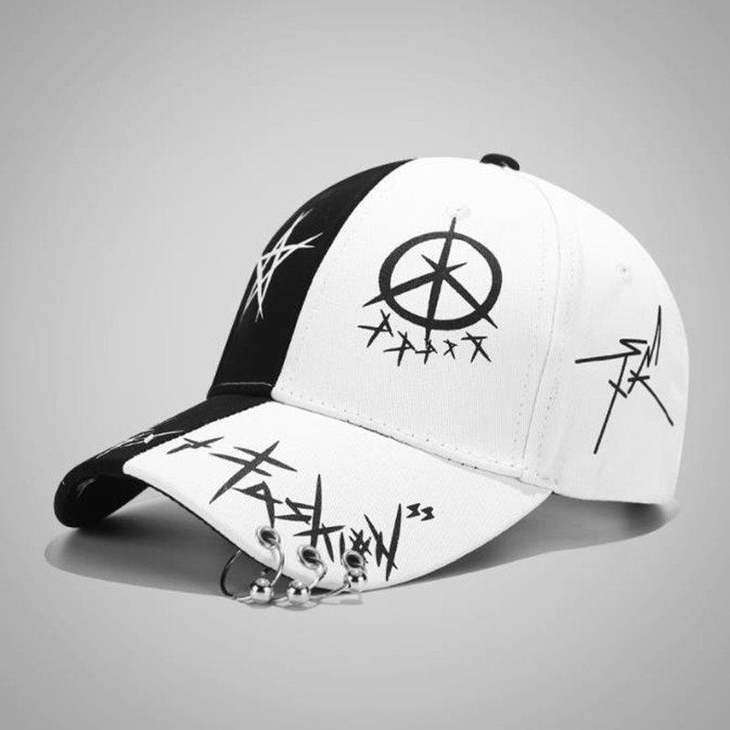 Erabyte Hat Man Baseball Cap featuring a black and white design with graphic symbols and a unique charm detail.