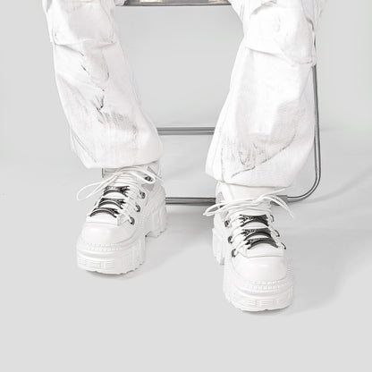 Extra-thick bottom punk boots by Erabyte in white, featuring chunky soles and metallic laces, worn with white marbled pants.