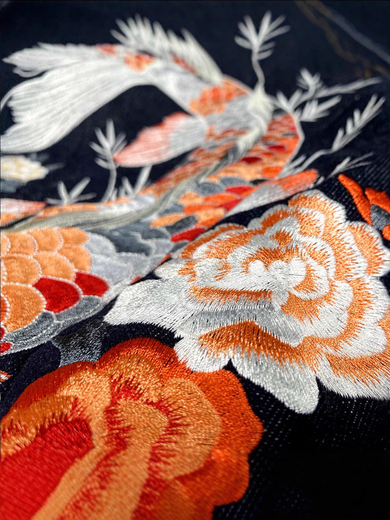 Close-up of Erabyte Embroidery Denim Jacket featuring vibrant floral and koi fish embroidery on dark denim. Retro loose fit d