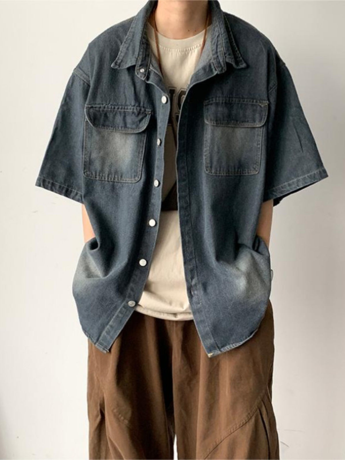 Men's denim short sleeve shirt jacket by Erabyte, featuring a relaxed fit, two chest pockets, and a faded blue wash.