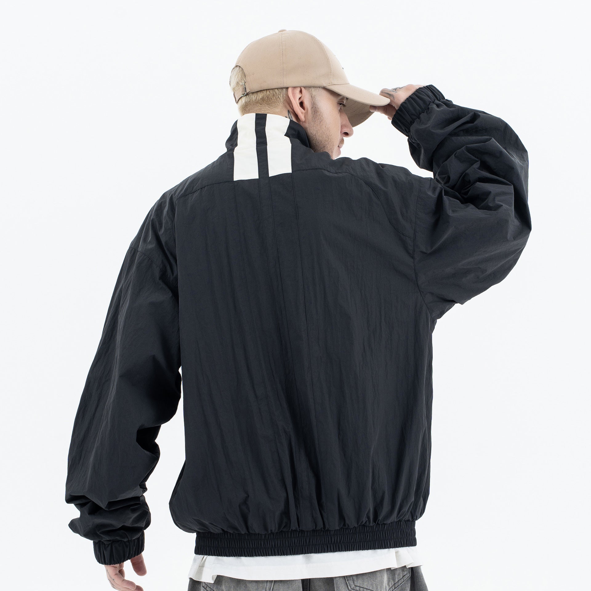 Men's jacket by Erabyte, featuring a relaxed fit, black fabric, and white stripe detail on the back.